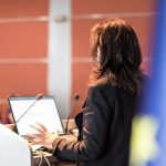 Public speaker giving talk at Business Event.